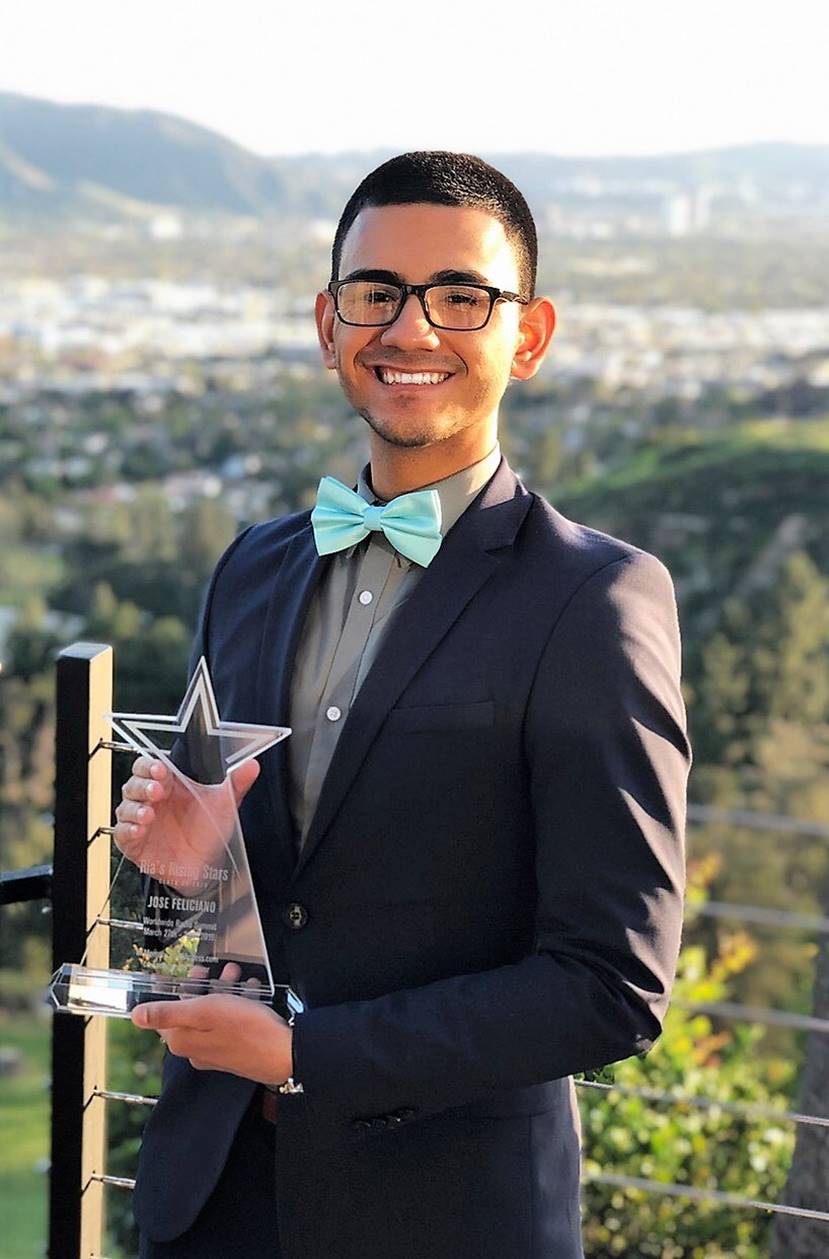 Jose holding his award