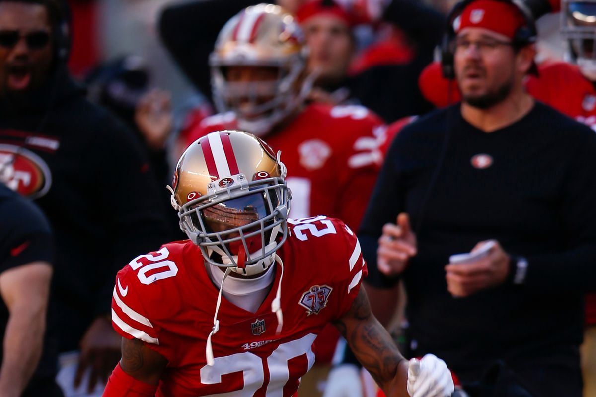 The 49ers stand on the field during an NFL game.