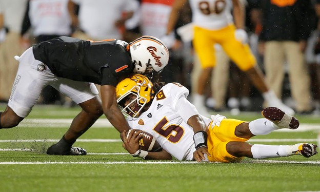 A Cowboys player taking down a Sundevil.