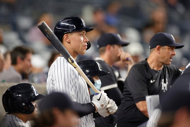 Aaron Judge stands in the New York Yankees' dugout during a game.