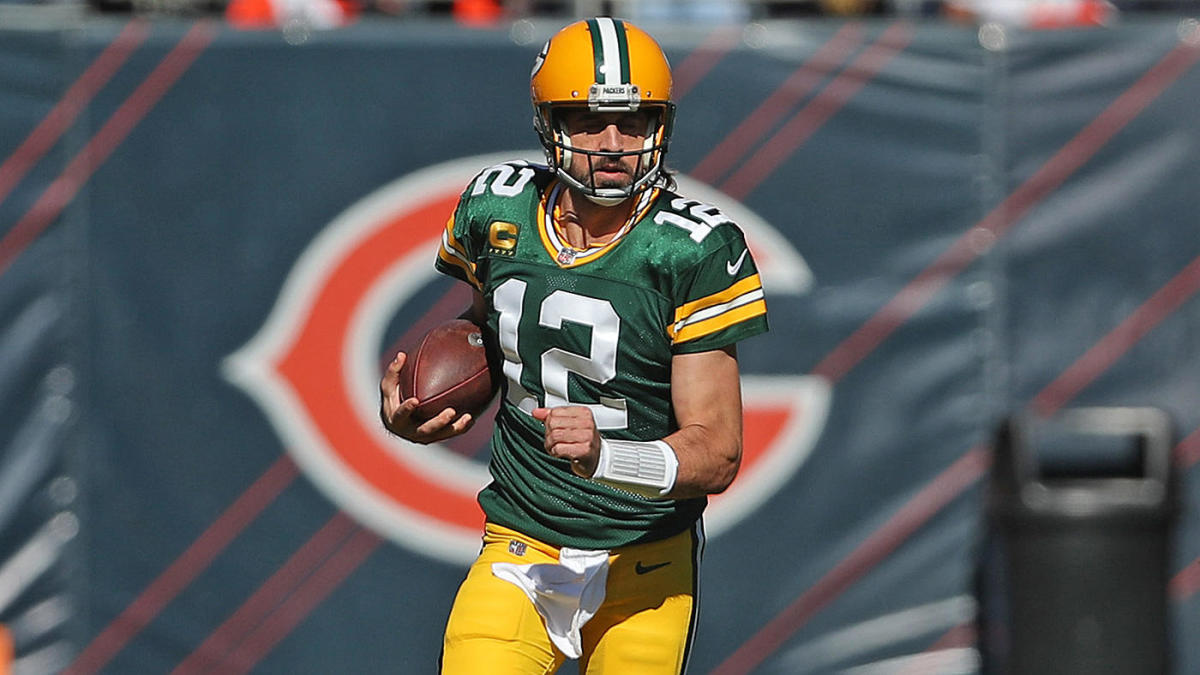 Aaron Rodgers stands on the field during a Green Bay Packers game.