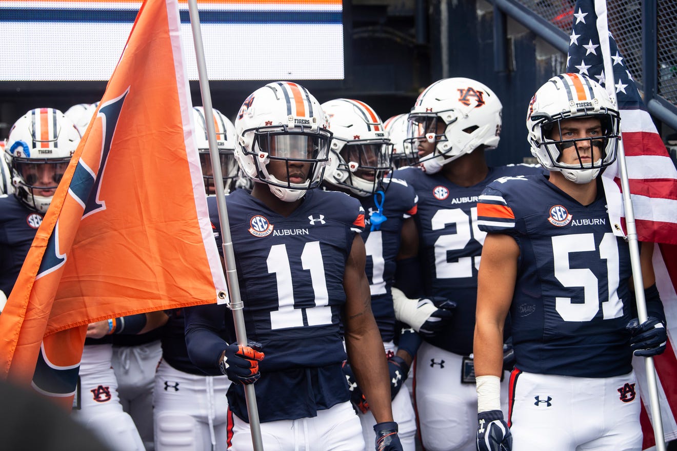 The Auburn football team stands in the tunnel before a college football game.