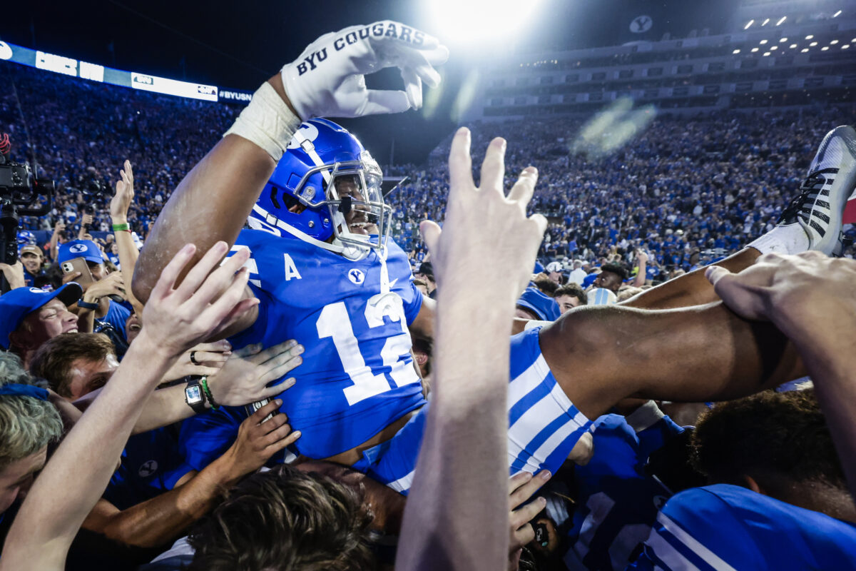 Students rush the field after an upset win over Baylor.