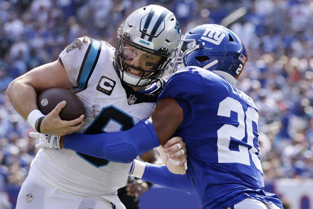 Baker Mayfield gets tackled by a Giants defender.