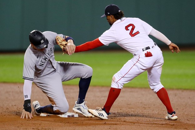 Xander Bogaerts tags a Yankee player during a Red Sox game at Fenway Park.