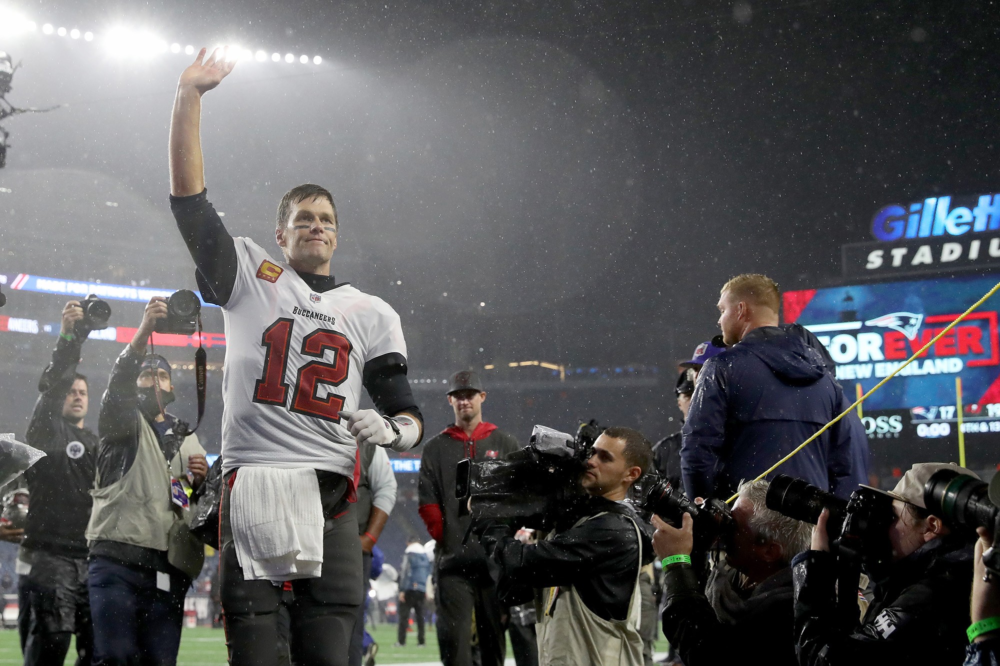 Tom Brady salutes the New England crowd after a Bucs-Patriots game.