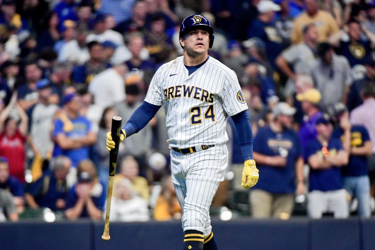 A Brewers player stands at home plate during a MLB game.
