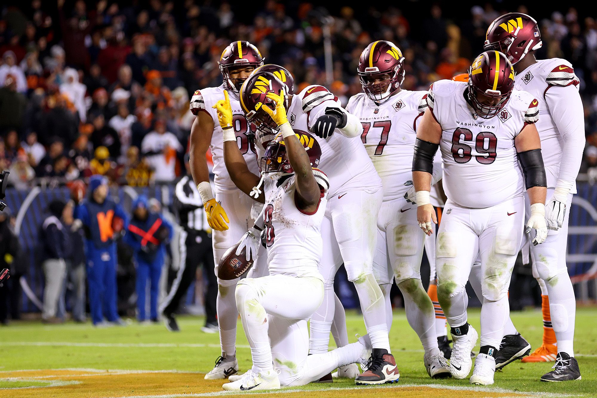 Brian Robinson reaches to the sky in celebration of his first NFL touchdown.