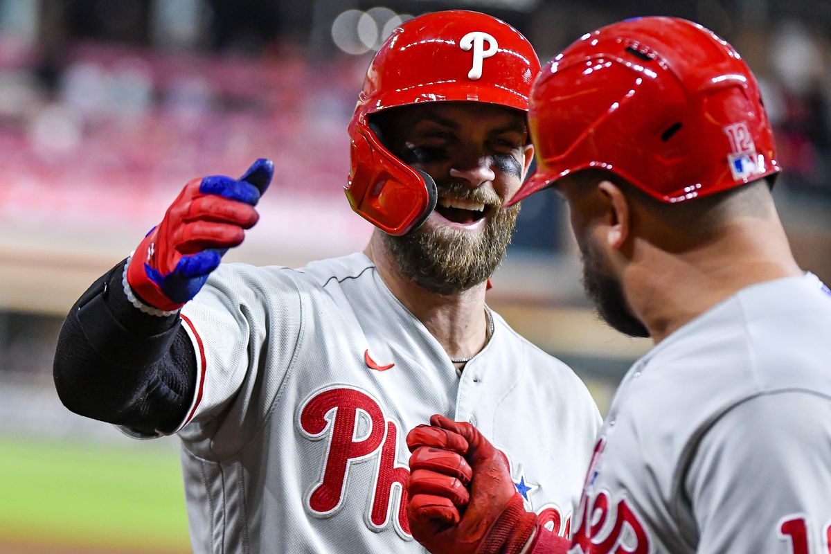 Bryce Harper embraces his teammate as the Phillies move on to the Divisional round.