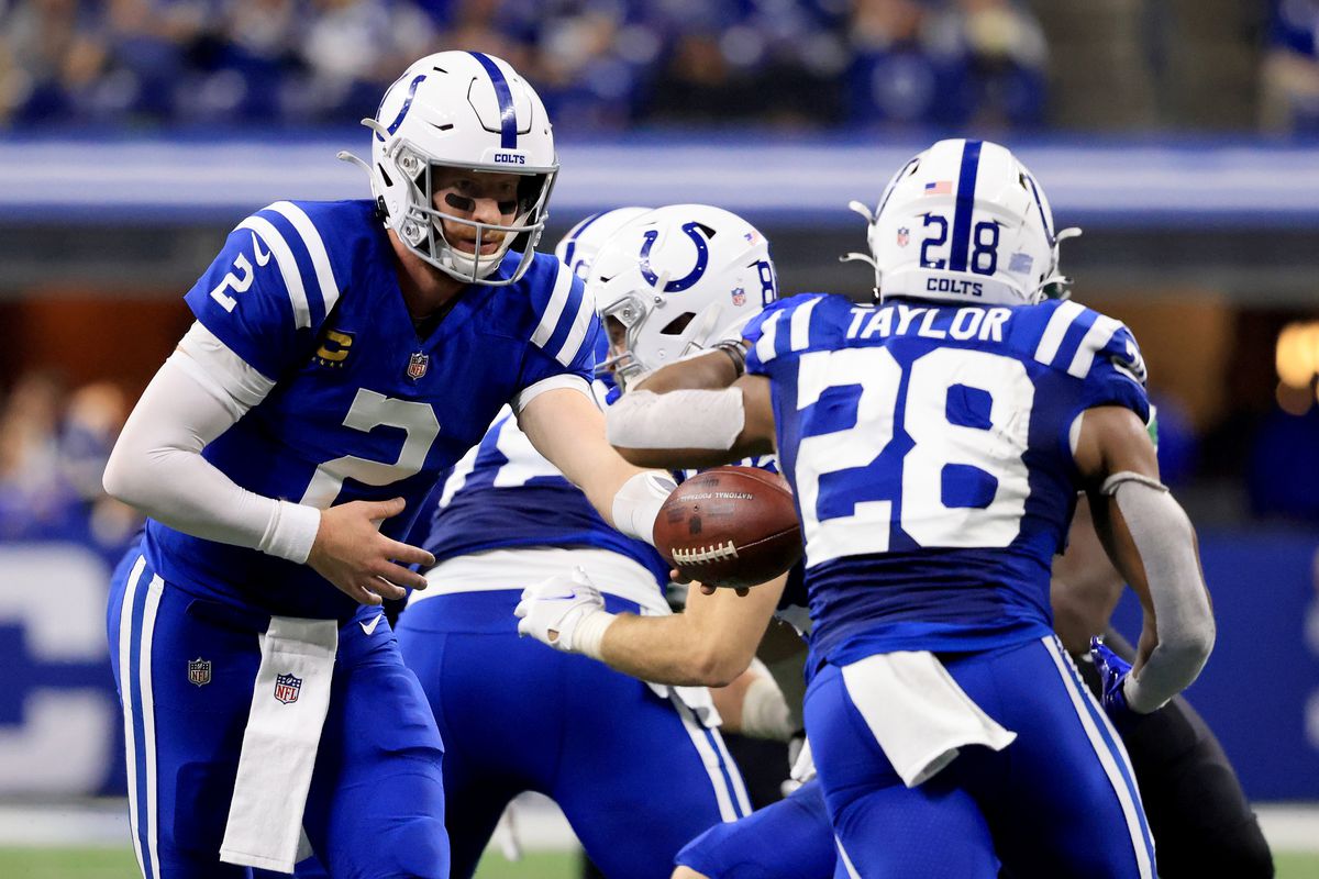 Carson Wentz hands the ball off to Jonathan Taylor during a Colts game.