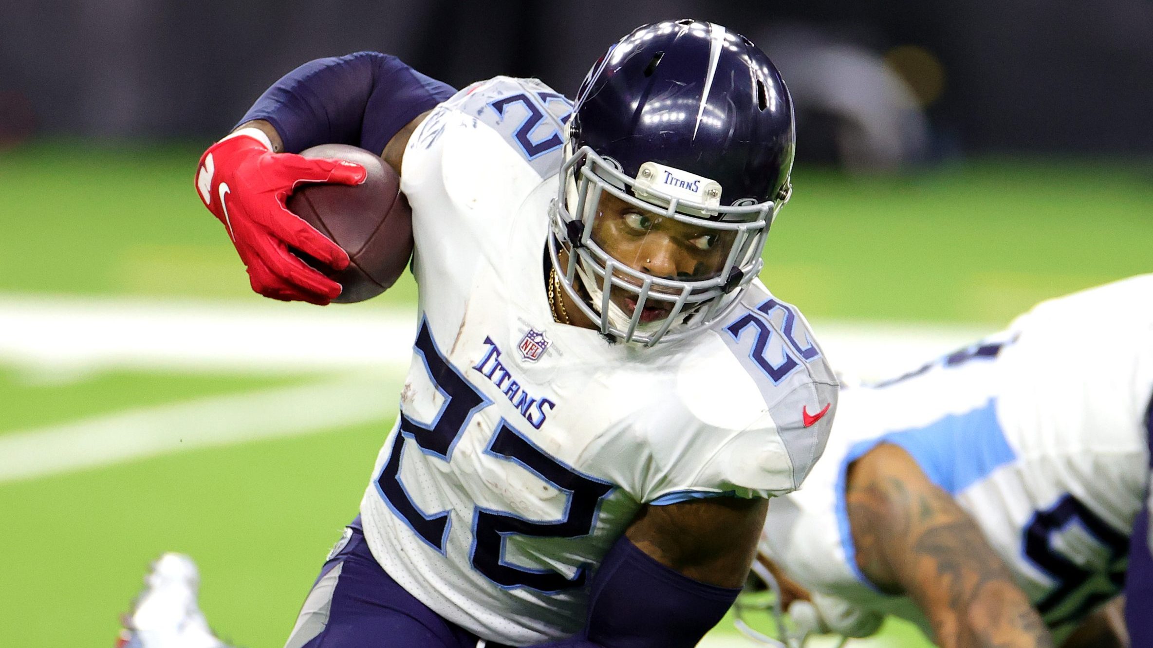 Tennessee's Derrick Henry avoids defenders during a Titans game.