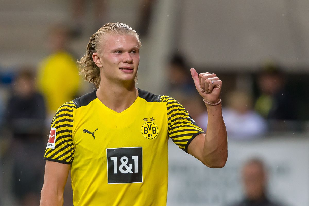 Erling Haaland gives a thumbs-up during a soccer game.