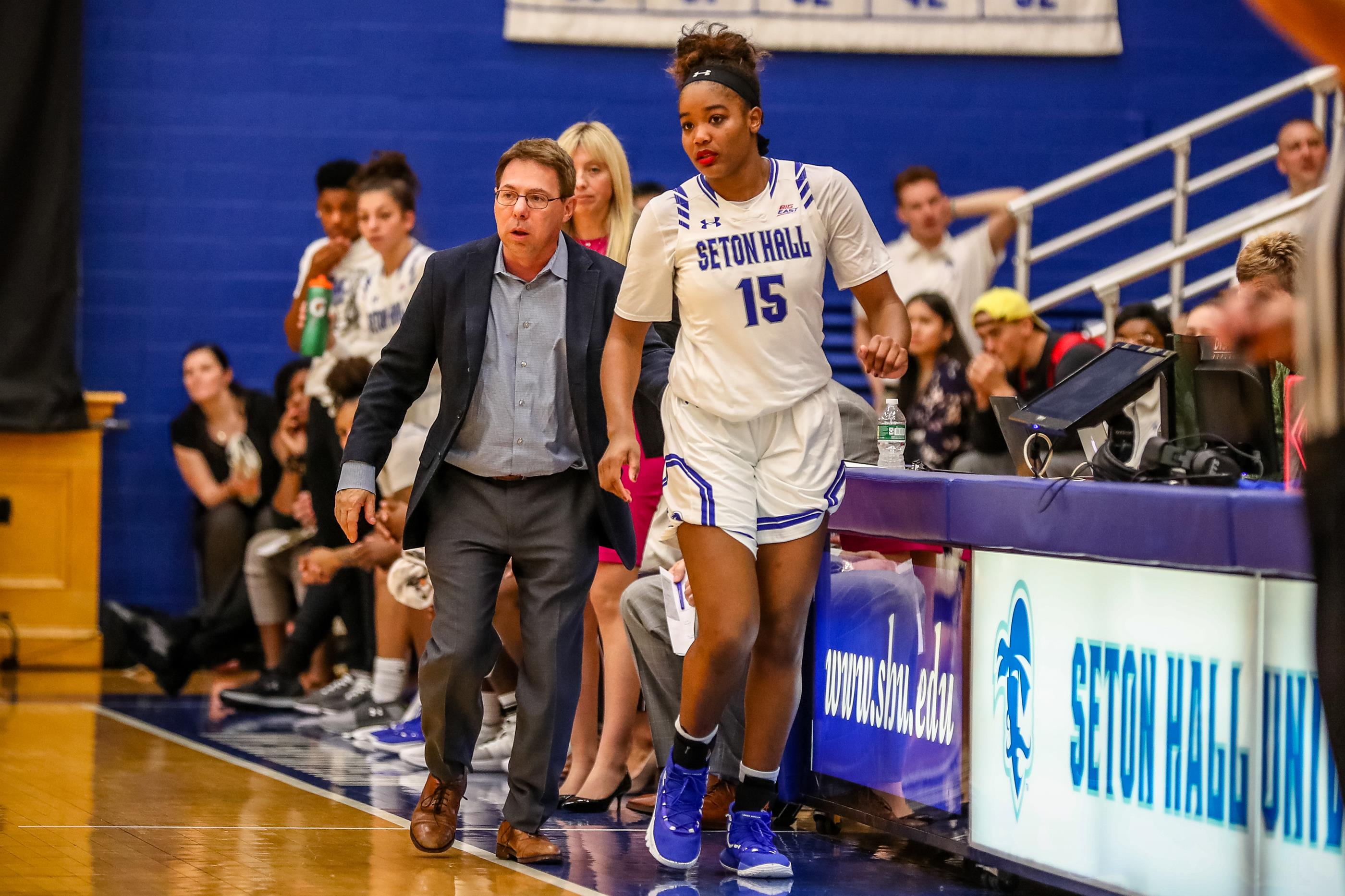 Seton Hall women's basketball's Femi Funeus stands on the sideline with Coach Bozzella.