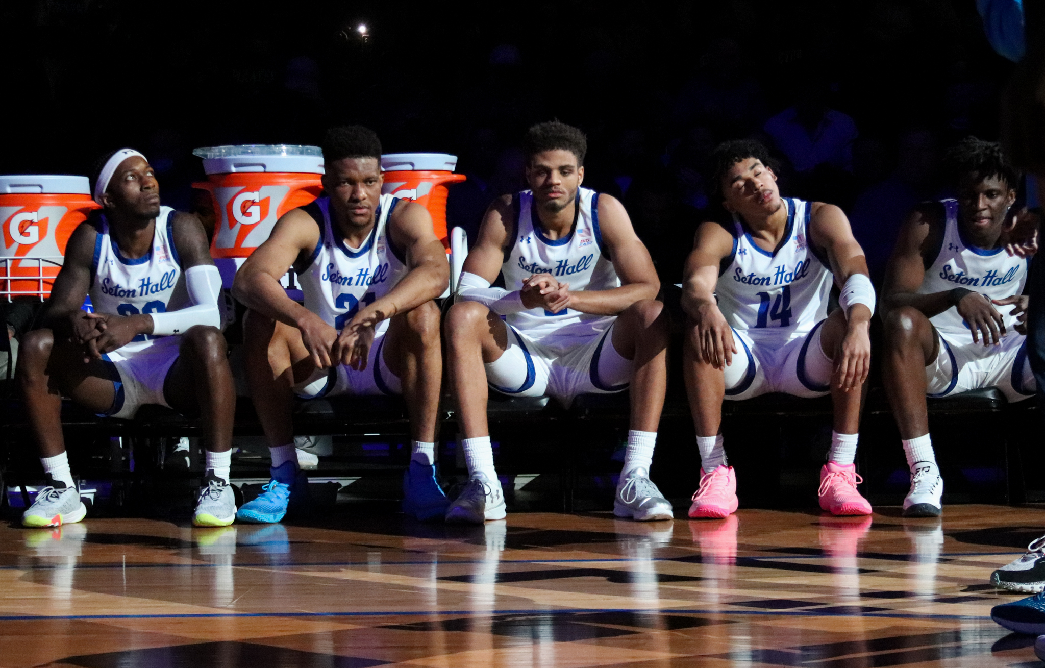 Members of the Seton Hall men's basketball team sit on the bench during pregame of a home matchup.