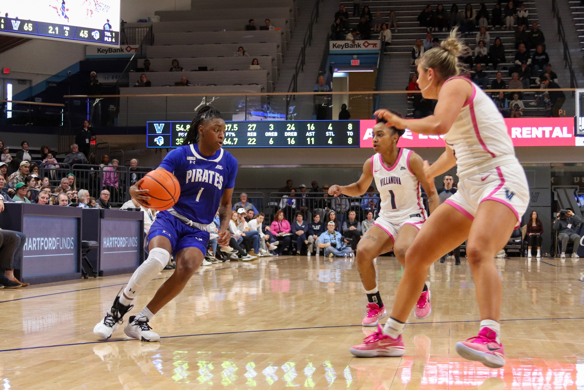 Shay Hagans splits two Nova defenders on her way to the hoop.