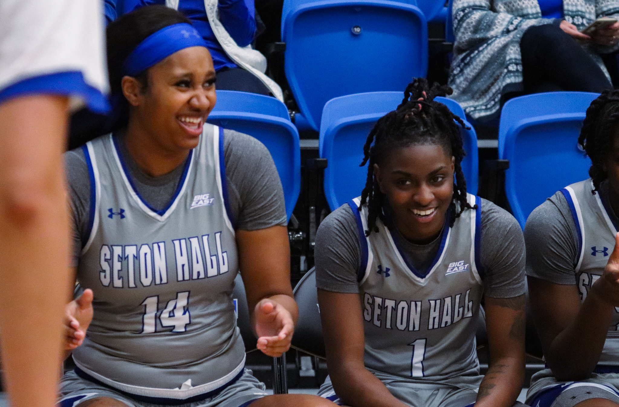 Sidney Cooks and Shay Hagans chat on the bench before getting on the court.