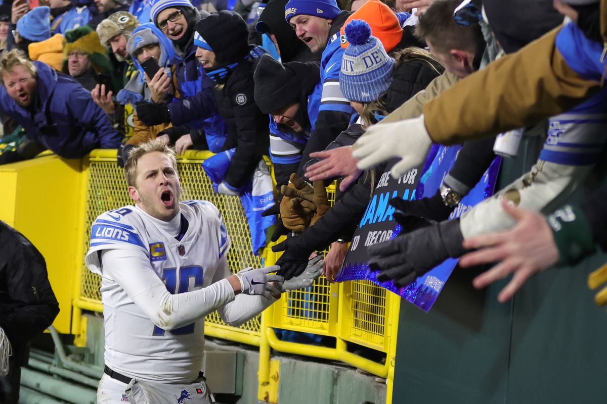 Jared Goff celebrates with Lions fans after a win against the Packers.