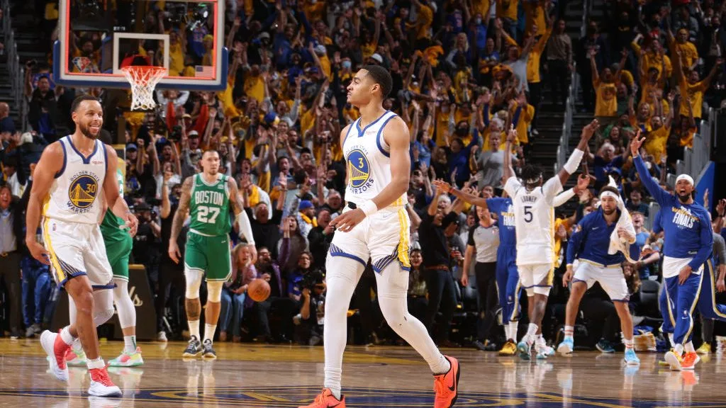 Jordan Poole celebrates on the court during the NBA Finals.