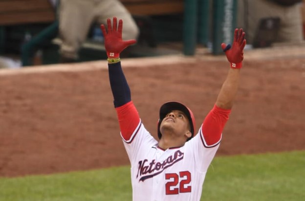 Juan Soto celebrates and puts his hands in the air during a Washington Nationals' game.