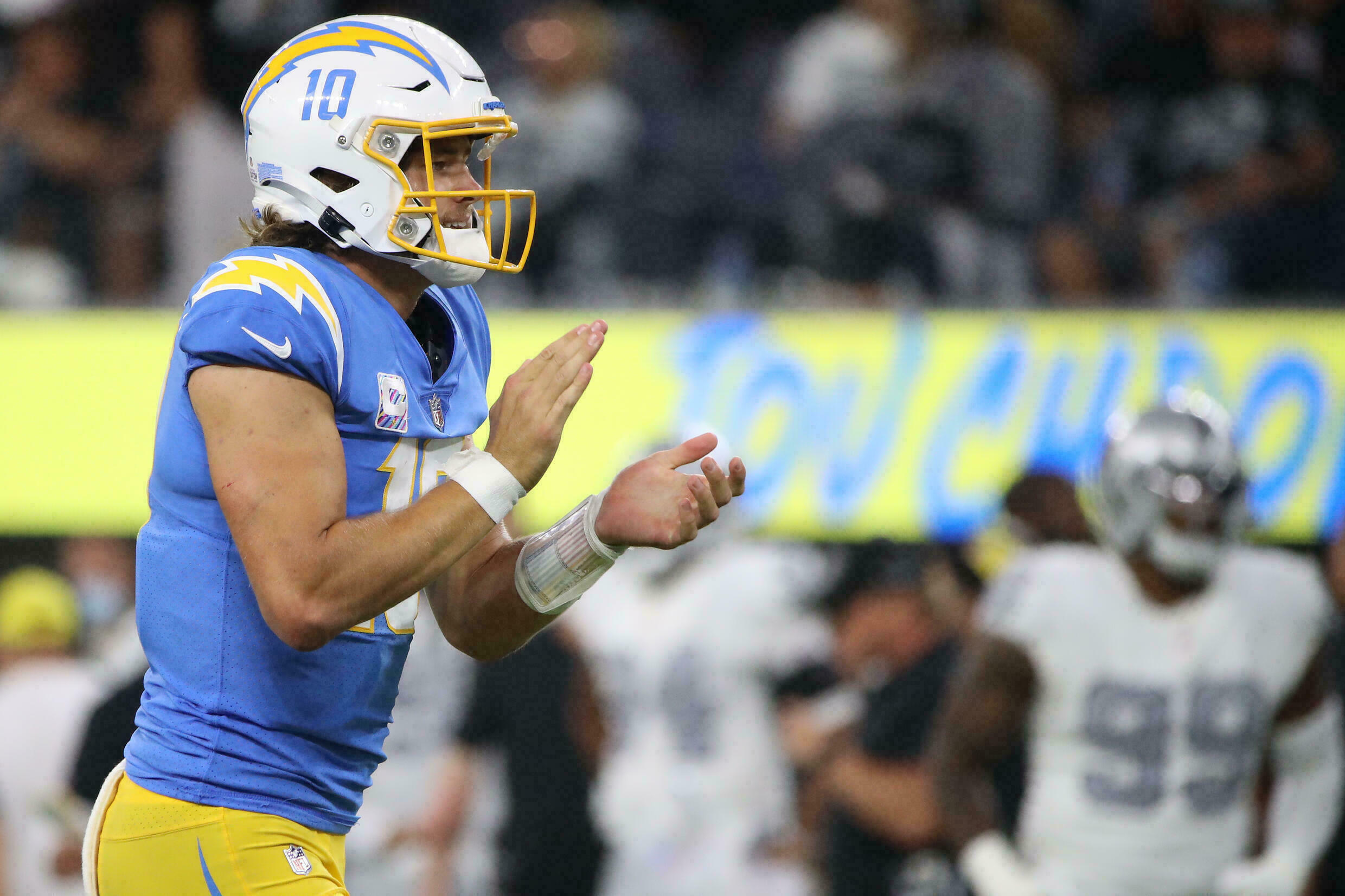 Justin Herbert celebrates during a NFL game against the Raiders.