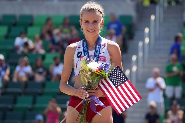 USA's Karissa Schweizer celebrates with flowers and a medal after winning in her event.