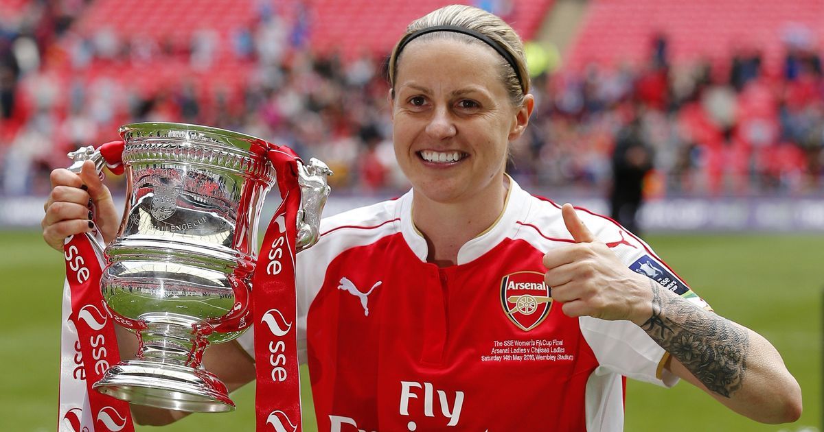 Former Seton Hall Pirate Kelly Smith holds a trophy and celebrates in a professional game.