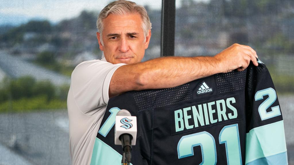 Seattle general manager Ron Francis shows who the first draft choice in Kraken history is, Matty Beniers.