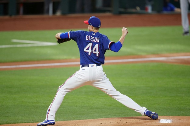 Texas Ranger Kyle Gibson throws a pitch from the mound during a MLB game.