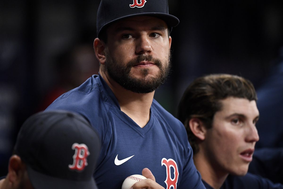 Red Sox member Kyle Schwarber sits on the bench during a game.