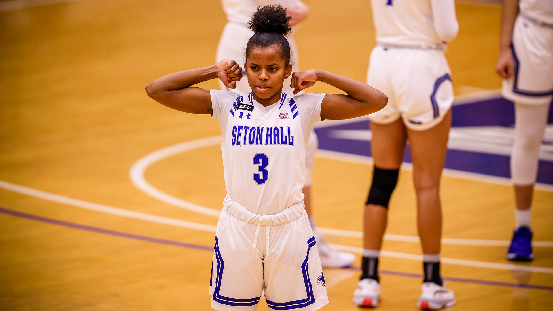 Lauren Park-Lane flexes her muscles during a Seton Hall women's basketball game.