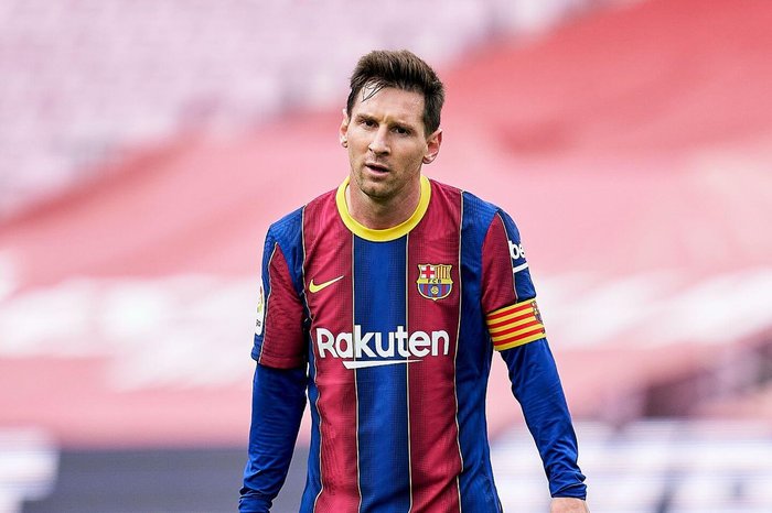 Barcelona's Lionel Messi walks on the field during a soccer game.