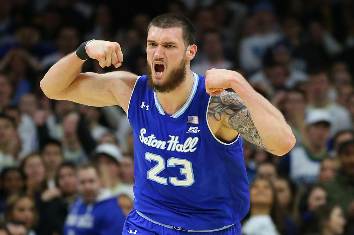 Sandro Mamukelashvili flexes his muscles during a Seton Hall men's basketball game.