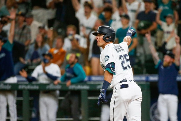 A Seattle Mariners batter celebrates after hitting a home run during an MLB game.