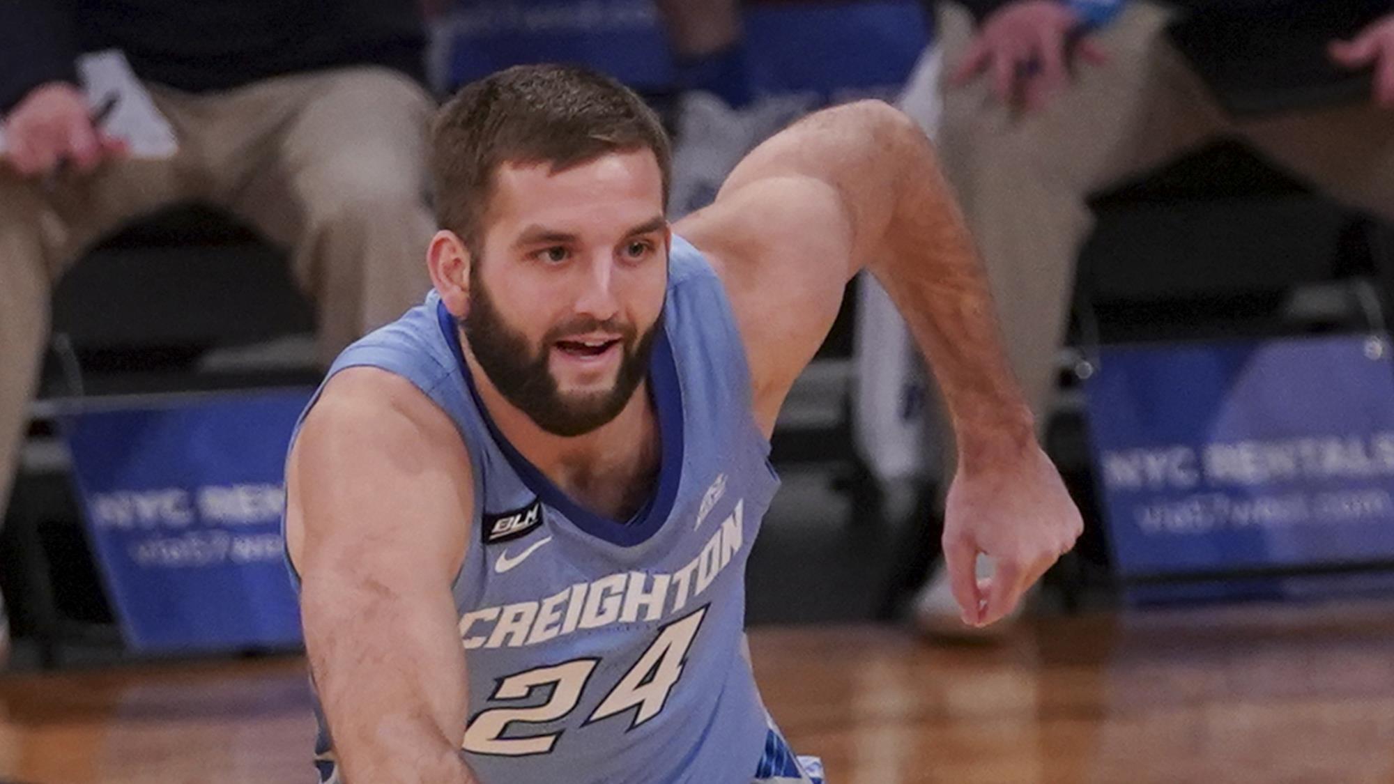 Mitch Ballock dribbles the ball past a defender during a Creighton game.