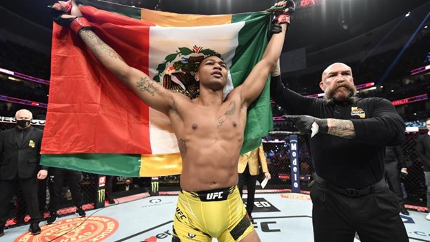 Morales holds the Mexican Flag after a hard fought Win.