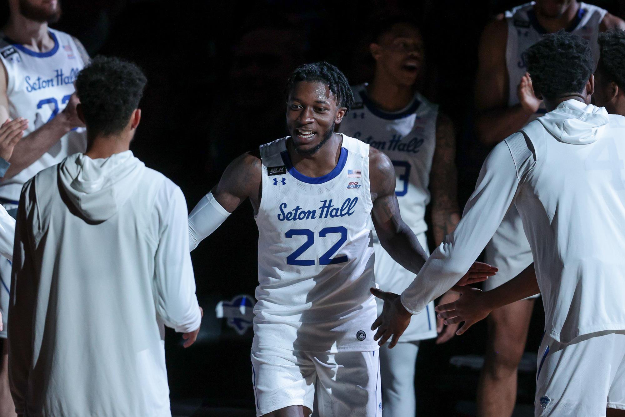 Myles Cale high fives teammates during pregame of a Seton Hall basketball game.