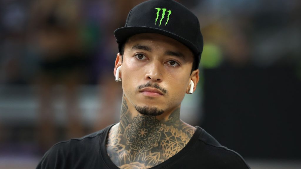 Nyjah Huston listens to music before he skates in a skateboarding competition.