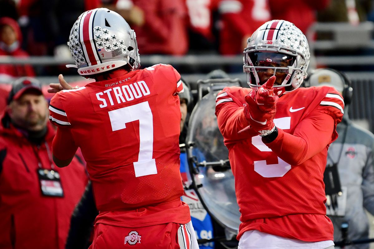 Two Ohio State football players celebrate during a college football game