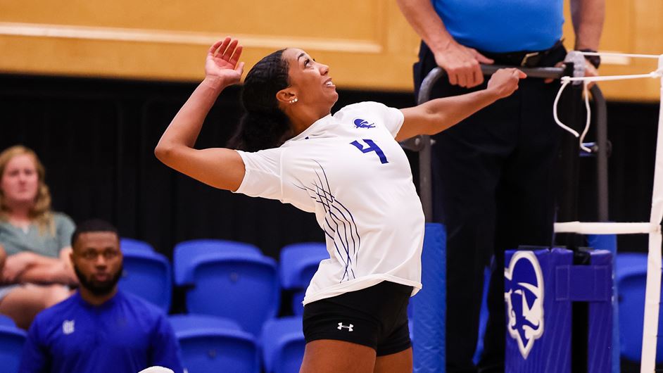 Perri Lucas spiking the ball over the net.