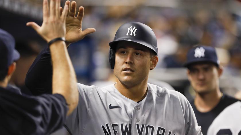 New York Yankees' Anthony Rizzo is congratulated by teammates in the dugout during a MLB game.