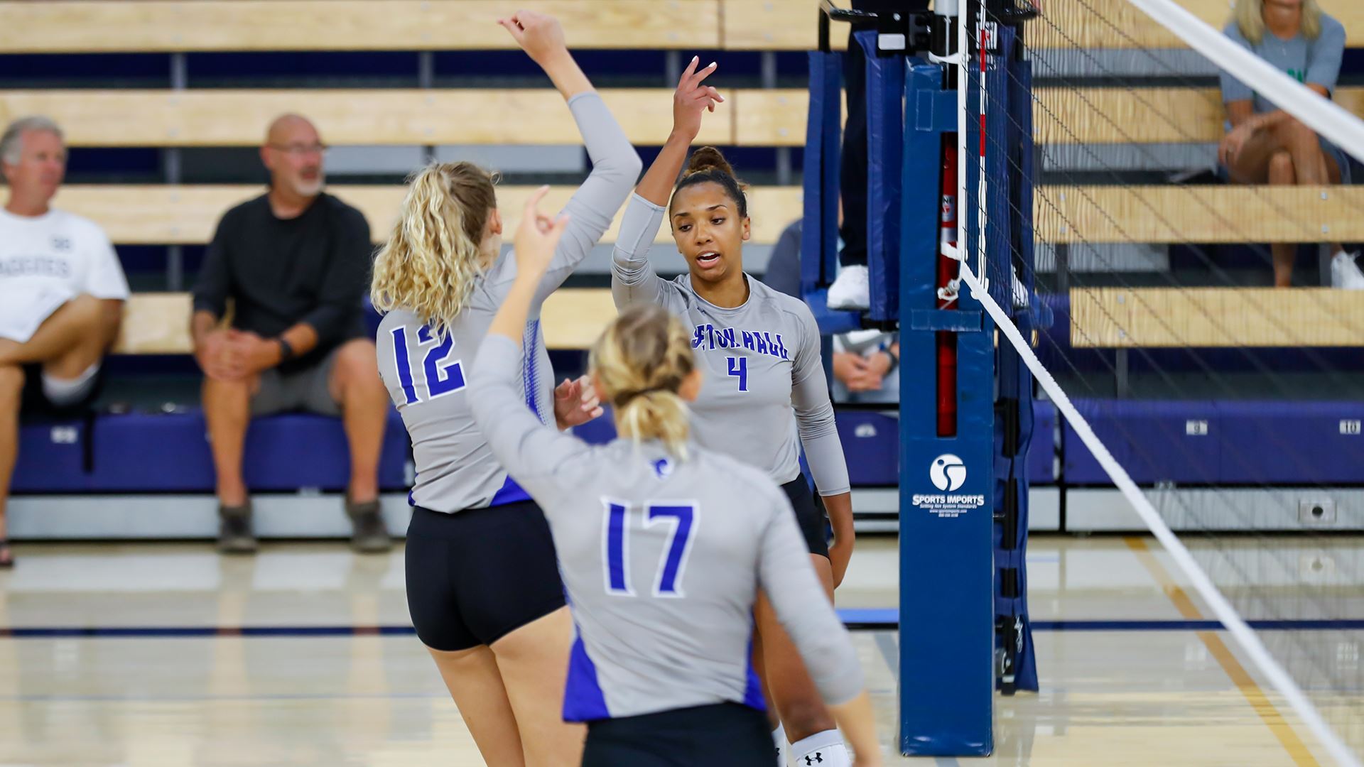 Seton Hall women's volleyball players celebrate during a match on the road.