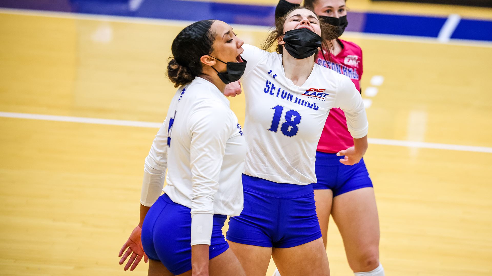 Seton Hall women's volleyball players celebrate after defeating Marist on the road.