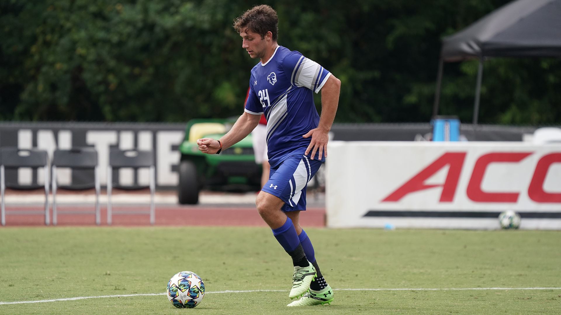 A Seton Hall men's soccer team player dribbles the ball during a game.