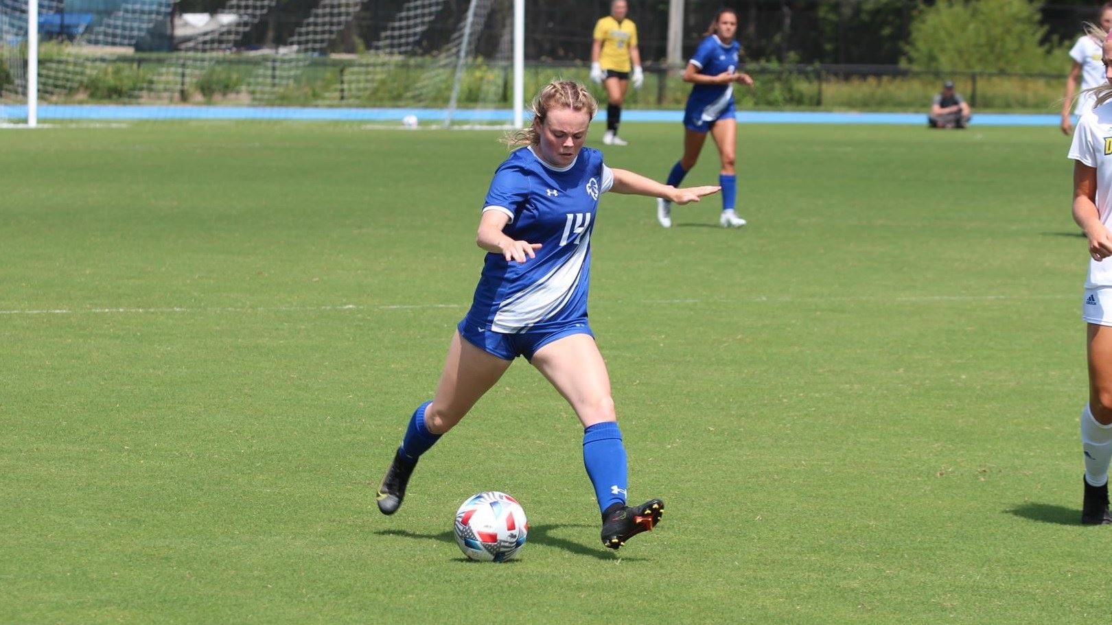 A Seton Hall women's soccer player dribbles and kicks the ball during a game against Drexel.