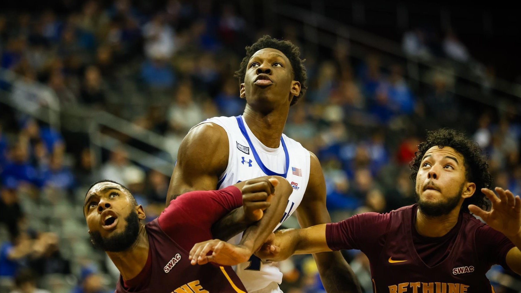 Seton Hall's Tyrese Samuel looks to grab a rebound over Bethune-Cookman players in a game at home.