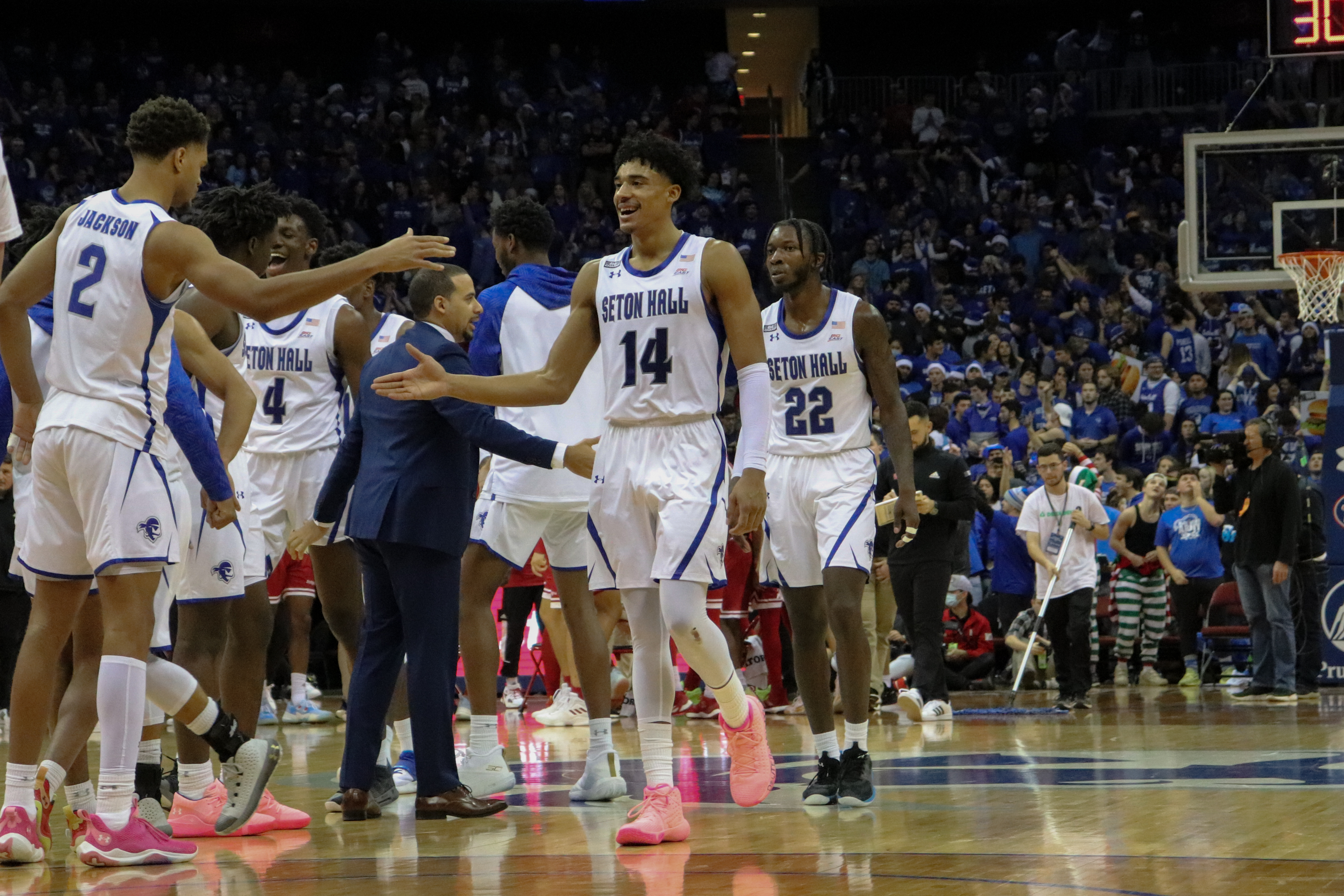 The Seton Hall men's basketball team high fives during a home game.