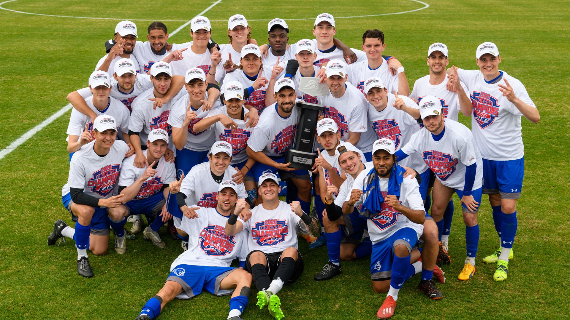 The Seton Hall men's soccer team celebrate their Big East Tournament title victory by posing for a photo.