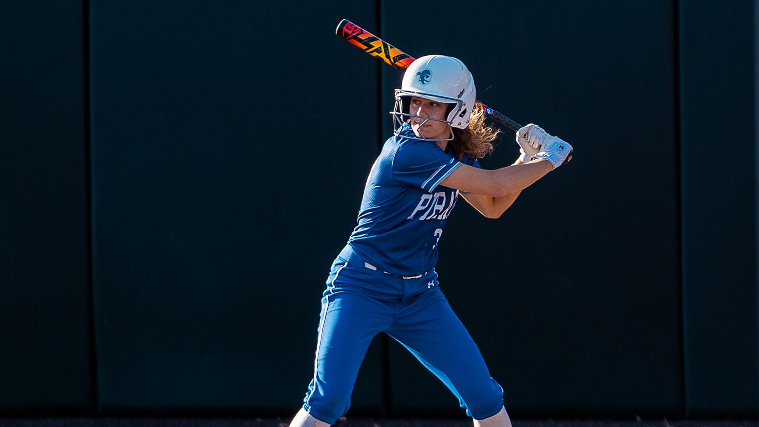 A Seton Hall softball player looks to bat during a game.