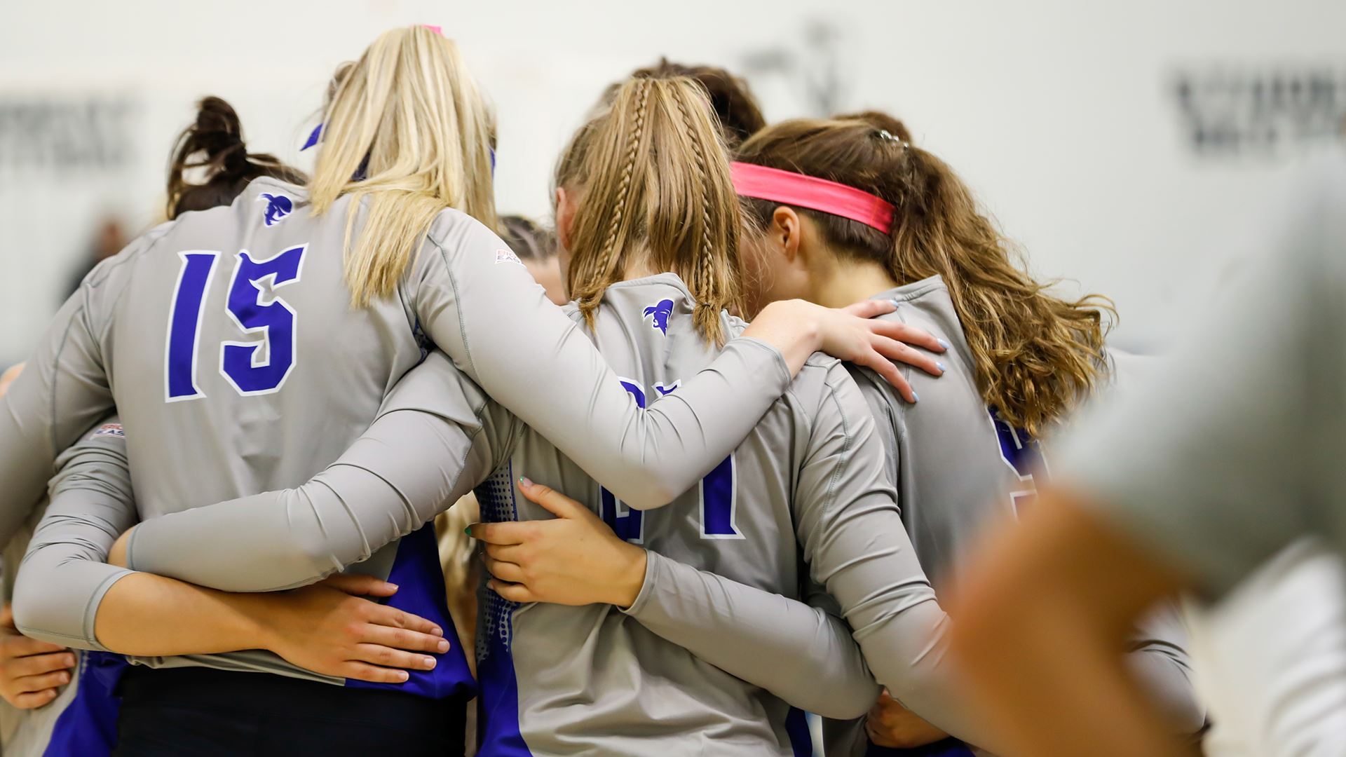 The Seton Hall women's volleyball team huddles before a match.