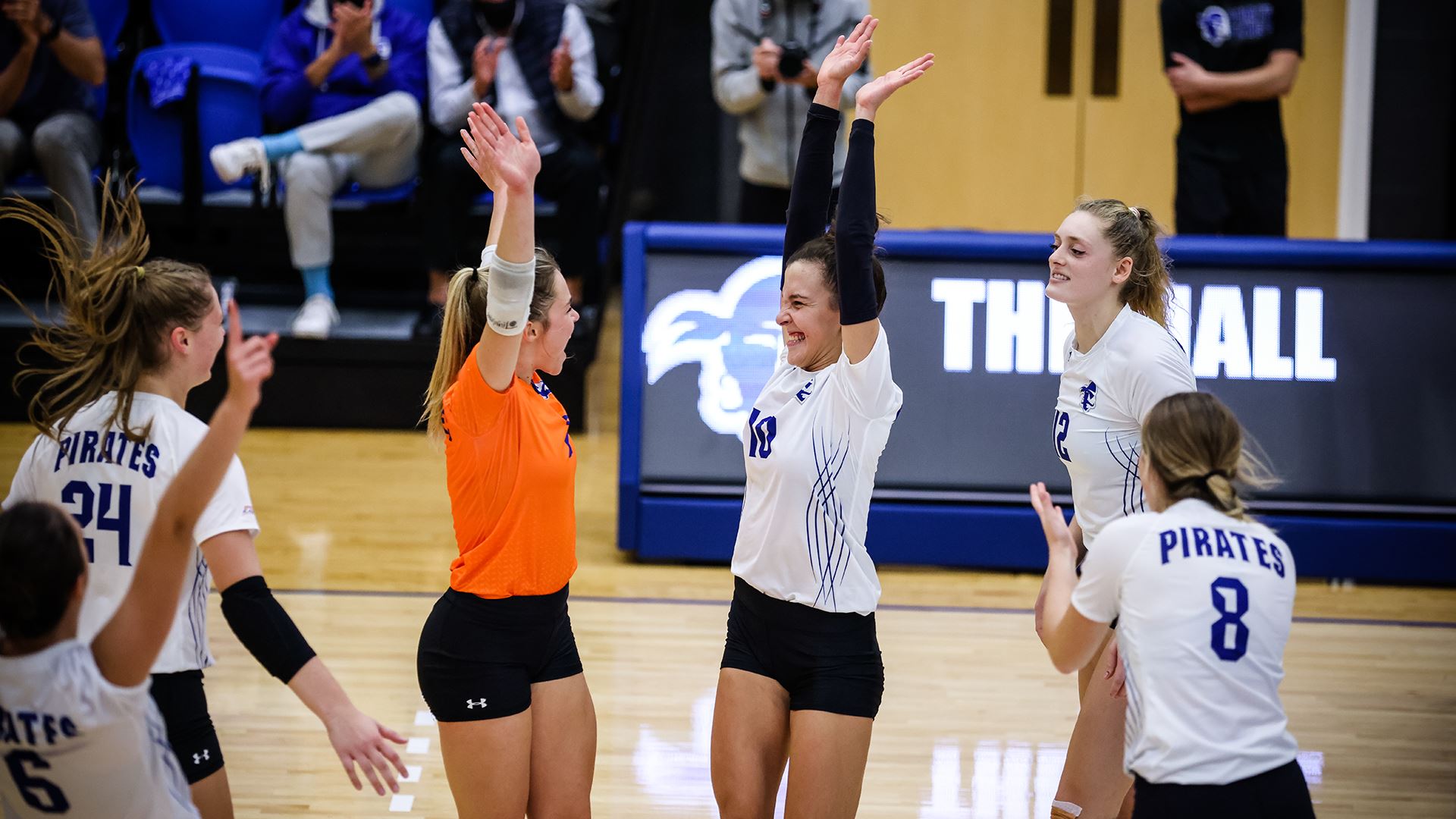 The Seton Hall women's volleyball team celebrates after winning a home match against Xavier.